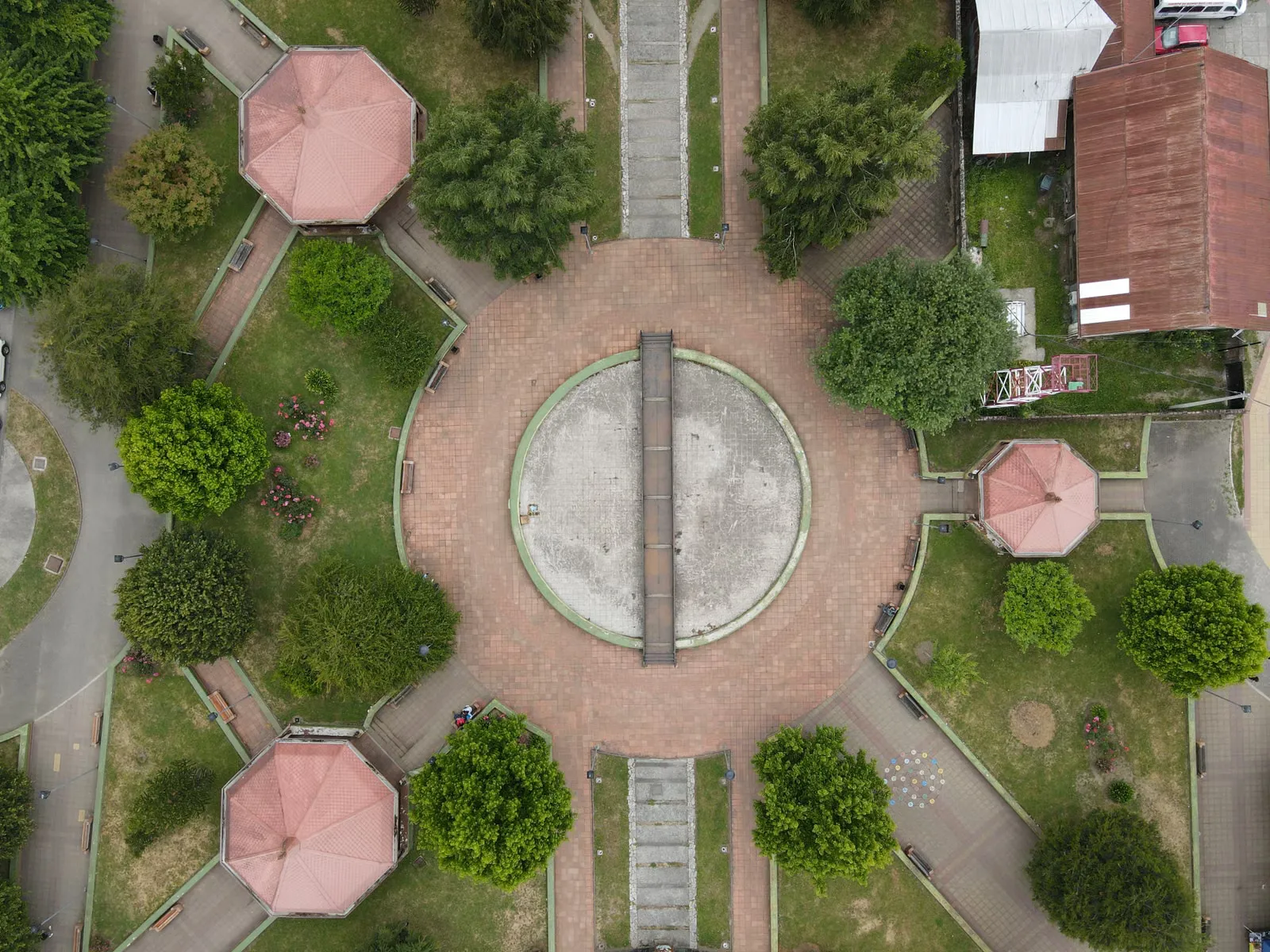 Vista aérea de una plaza urbana de Chile con senderos y vegetación.