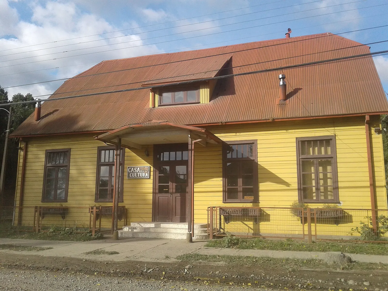 Casa de la Cultura de Máfil, Región de Los Ríos: edificio de madera pintado de amarillo con techo de zinc rojizo.